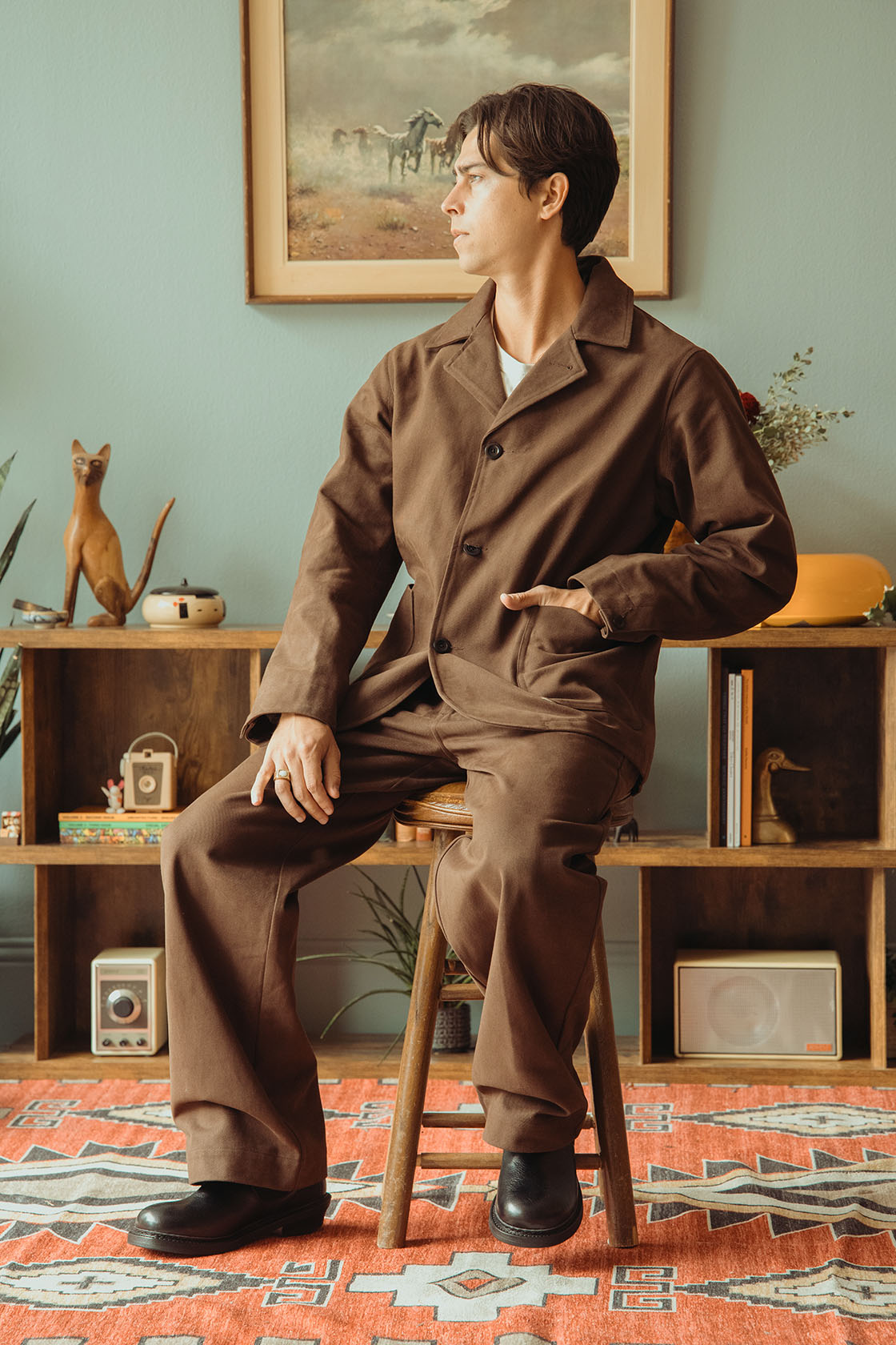 Image of model wearing Conkers Bruton Blazer in dark brown with hands in pocket