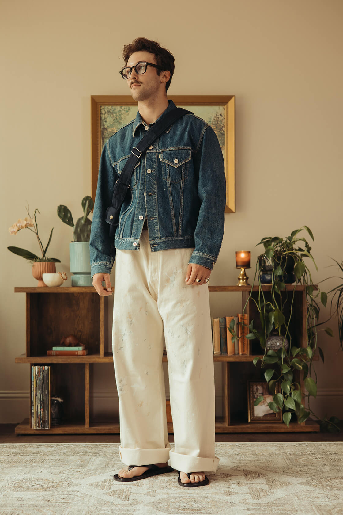 Taiga Takahashi Lot. 303 Coverall Jacket in Mix Brown, Hender Scheme Leather Nest Bag in Natural, FrizmWORKS OG Oversized Stripe Shirt in Blue, Auralee Light Wool Max Gabardine Shorts in Dark Brown, and Visvim Landers Boots-Folk in Black.