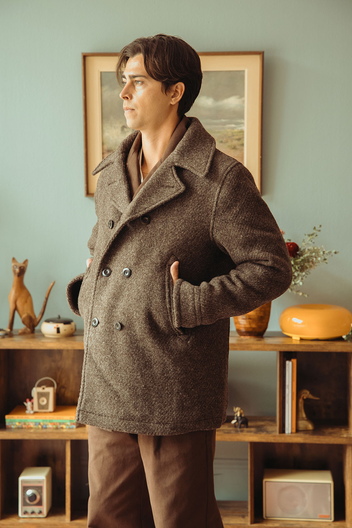 Model wearing Conkers Balwen Peacoat in Yew Marl with hands in pocket.