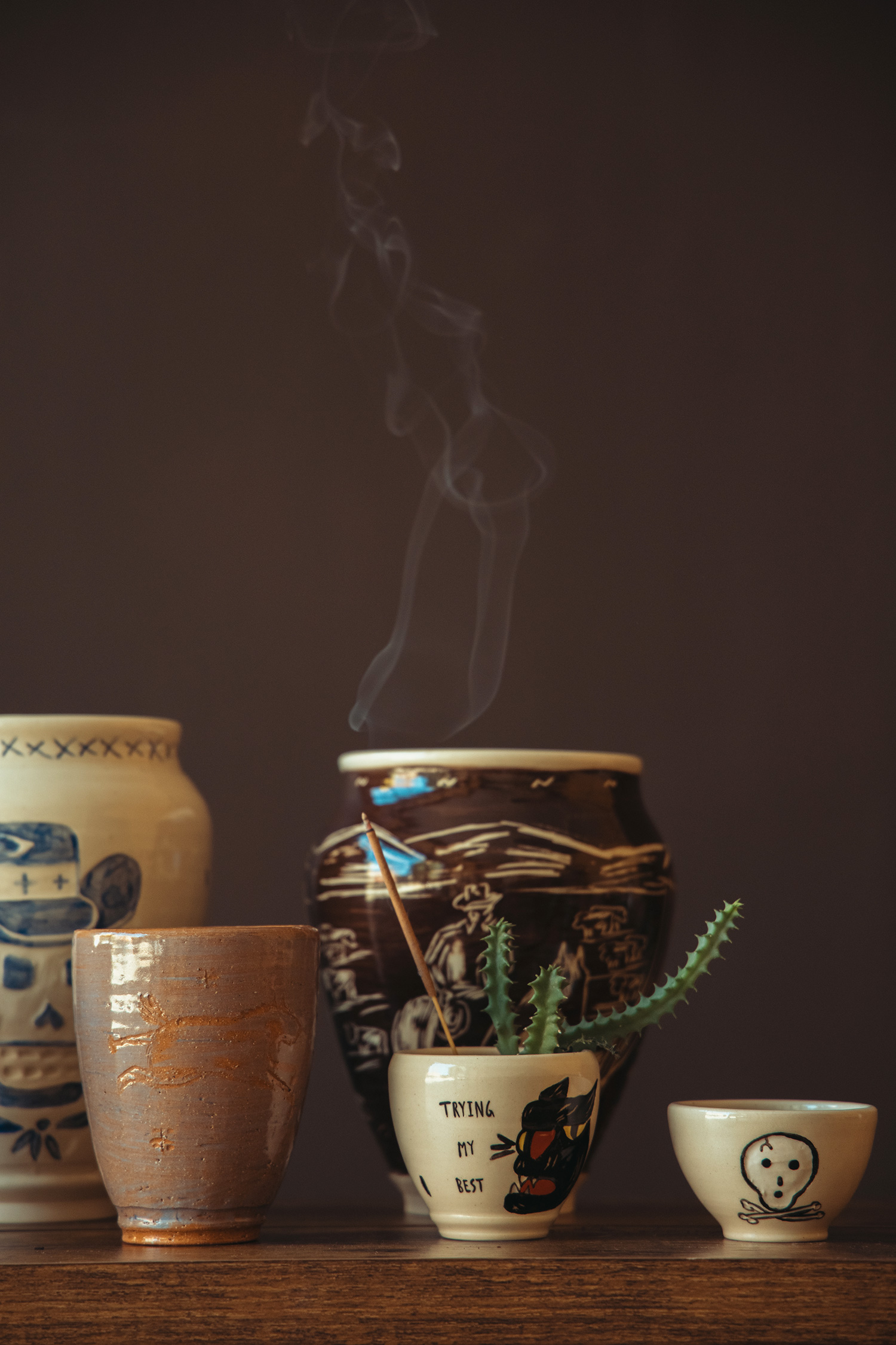 Canoe Club x Ebbets Field Ball Cap in Black, Taiga Takahashi (T.T.) Lot.103 Work Shirt P/O in Light Brown, Kapital Fastcolor Selvedge Bandanna (PaisleyPatchwork) in Khaki/Green, OrSlow US Army 2 Pocket Cargo Pants in Green, and Our Legacy Cortege Boot in Deep Black Leather.