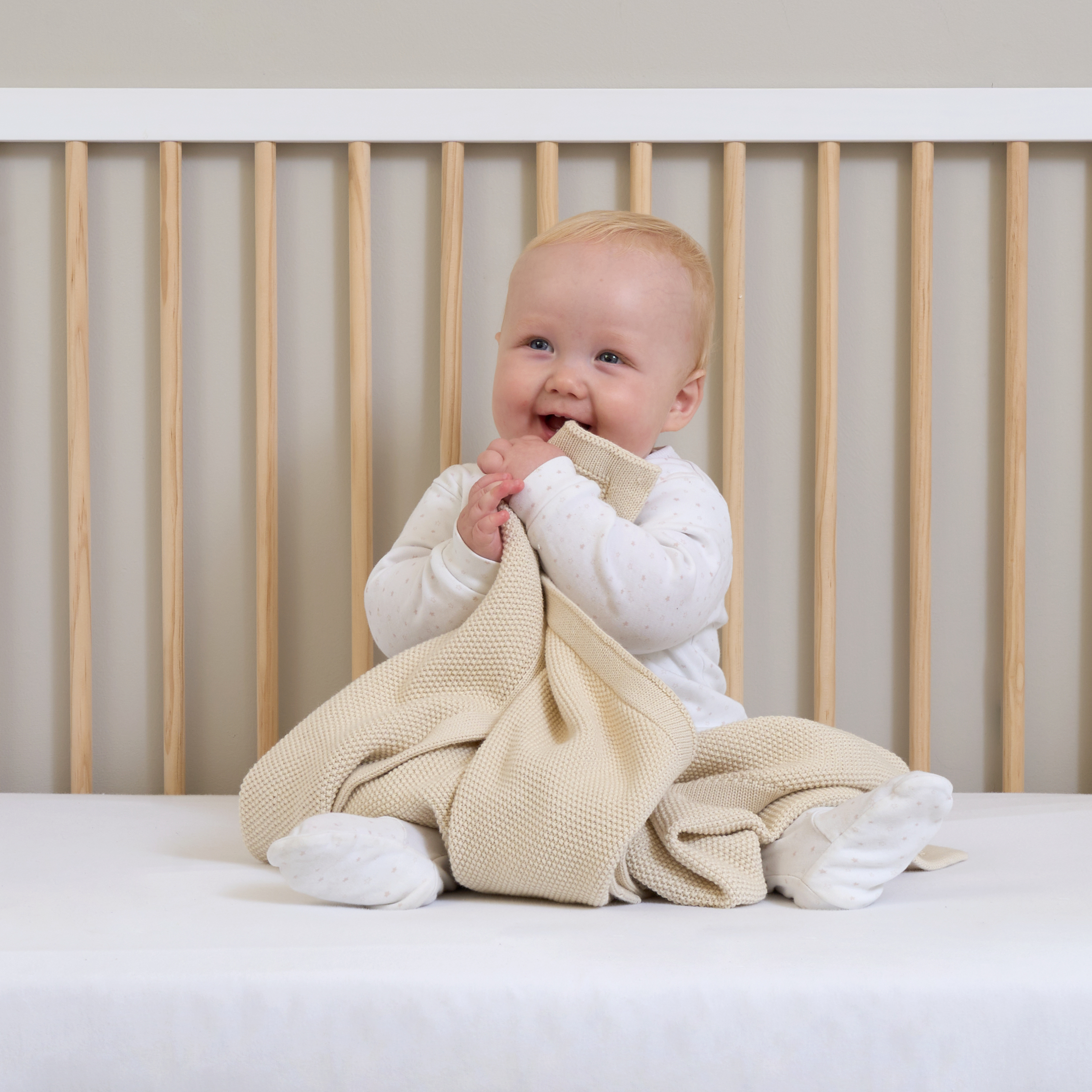 Baby holding the cream Organic Knitted Blanket