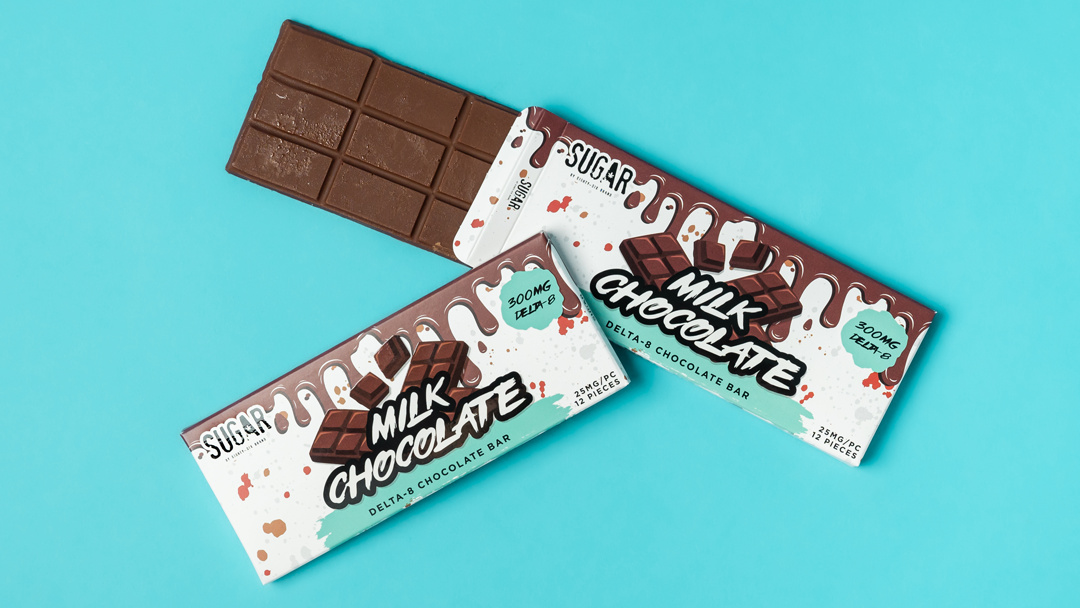 Delta-8 THC milk chocolate bar on a blue background