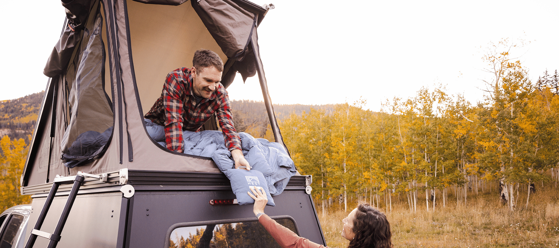 Two HEST Foamy mattresses linked in a rooftop tent for couple sleeping
