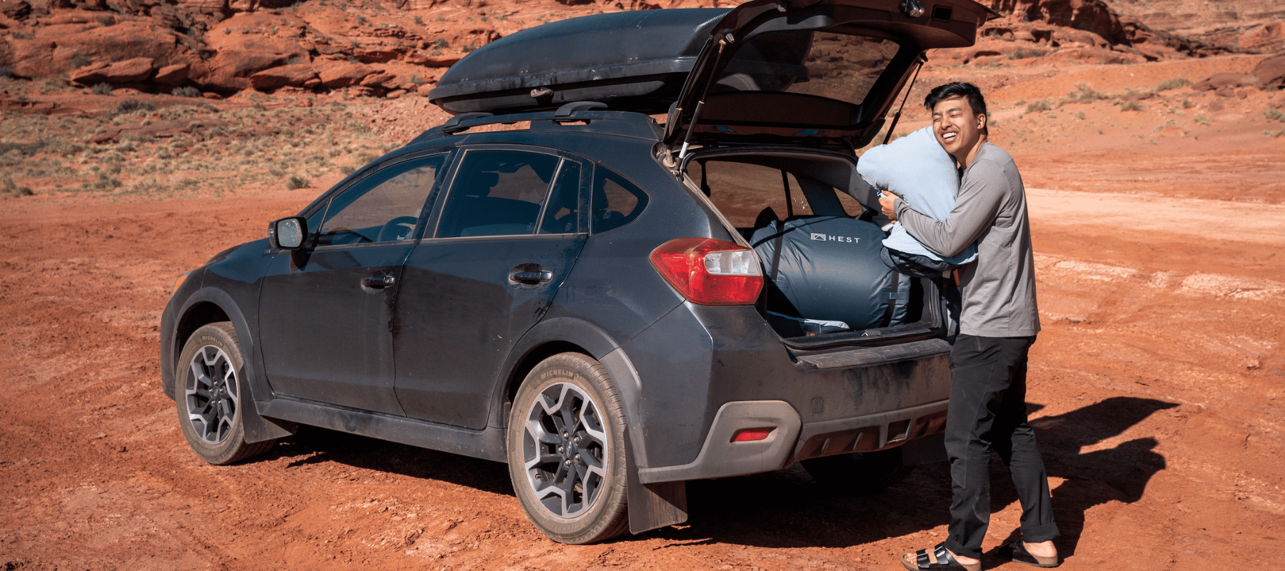 Trailhead overnight car camping setup with HEST Foamy unrolled in SUV