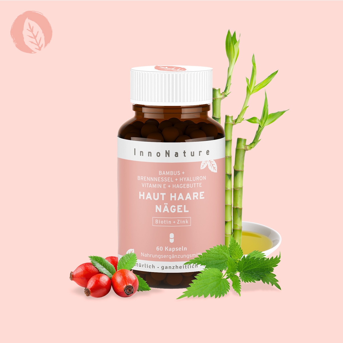 dose-haut-haare-naegel-kapseln-von-innonature-vor-rosa-hintergrund-bambus-und-brennnessel-hinter-der-dose