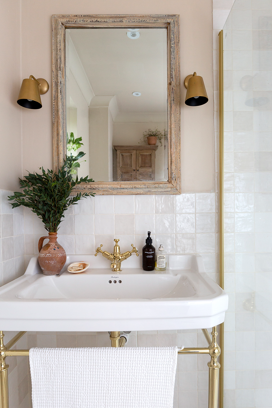 white and pink bathroom with glossy zellige wall tiles and sink