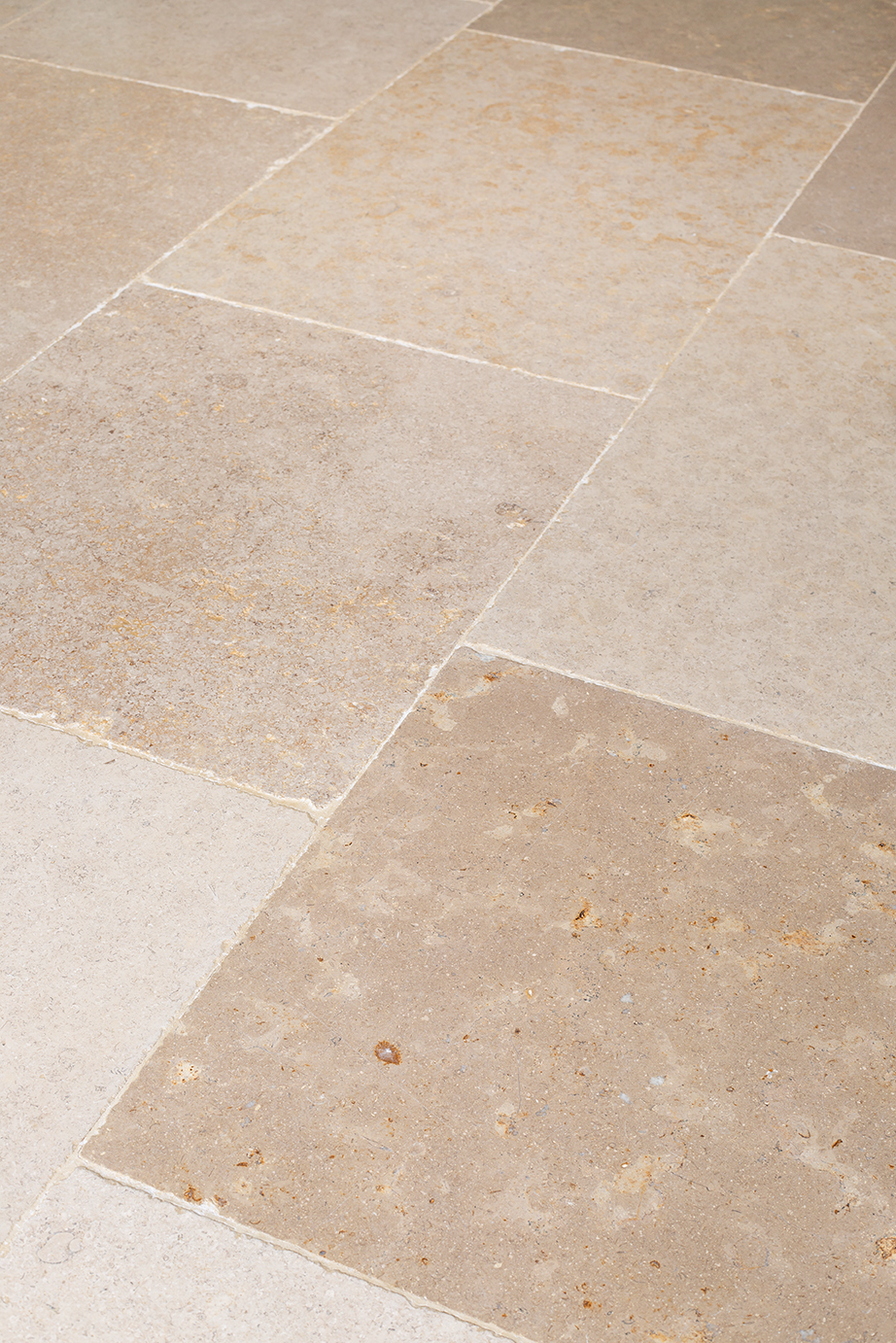 A close up of Dijon Limestone tiled flooring.