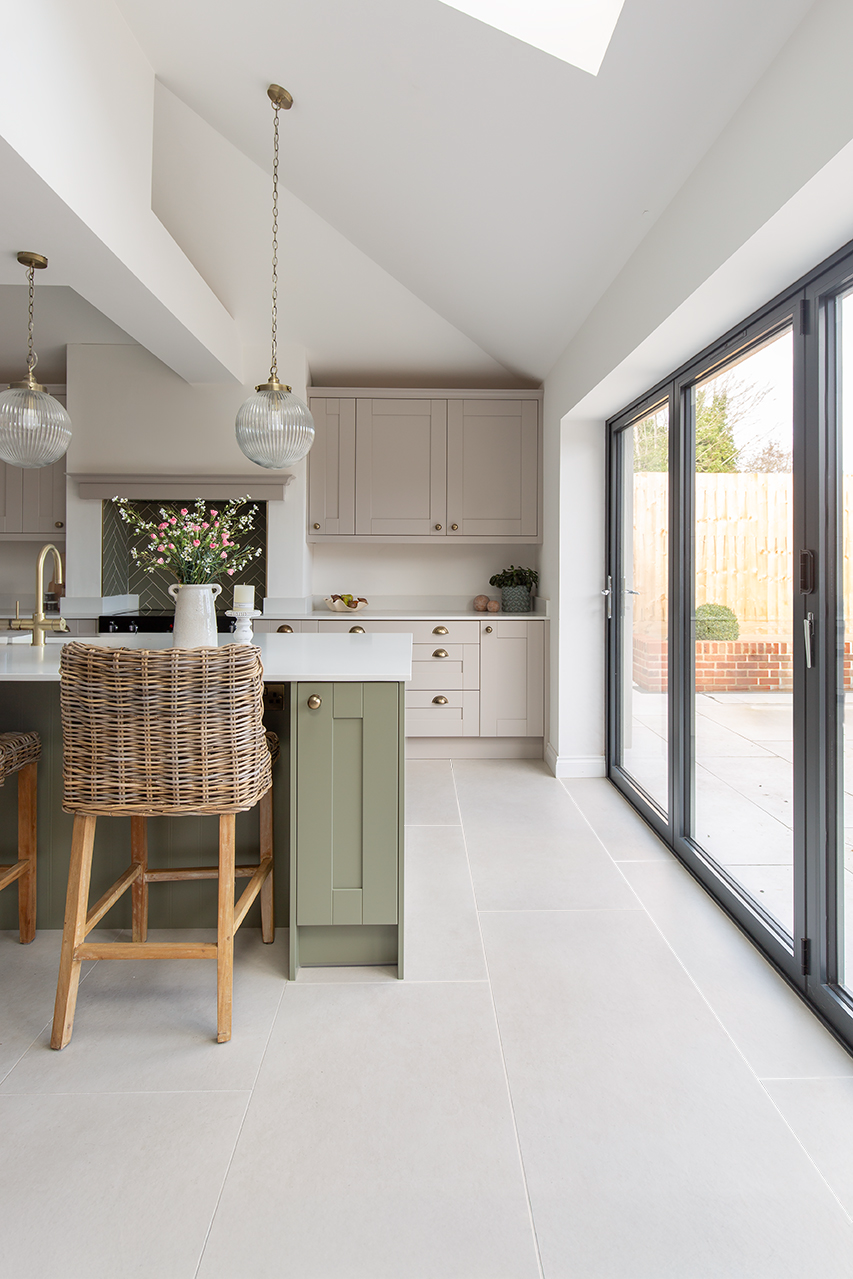 Frome White stone effect flooring with a green kitchen island and wooden stool 