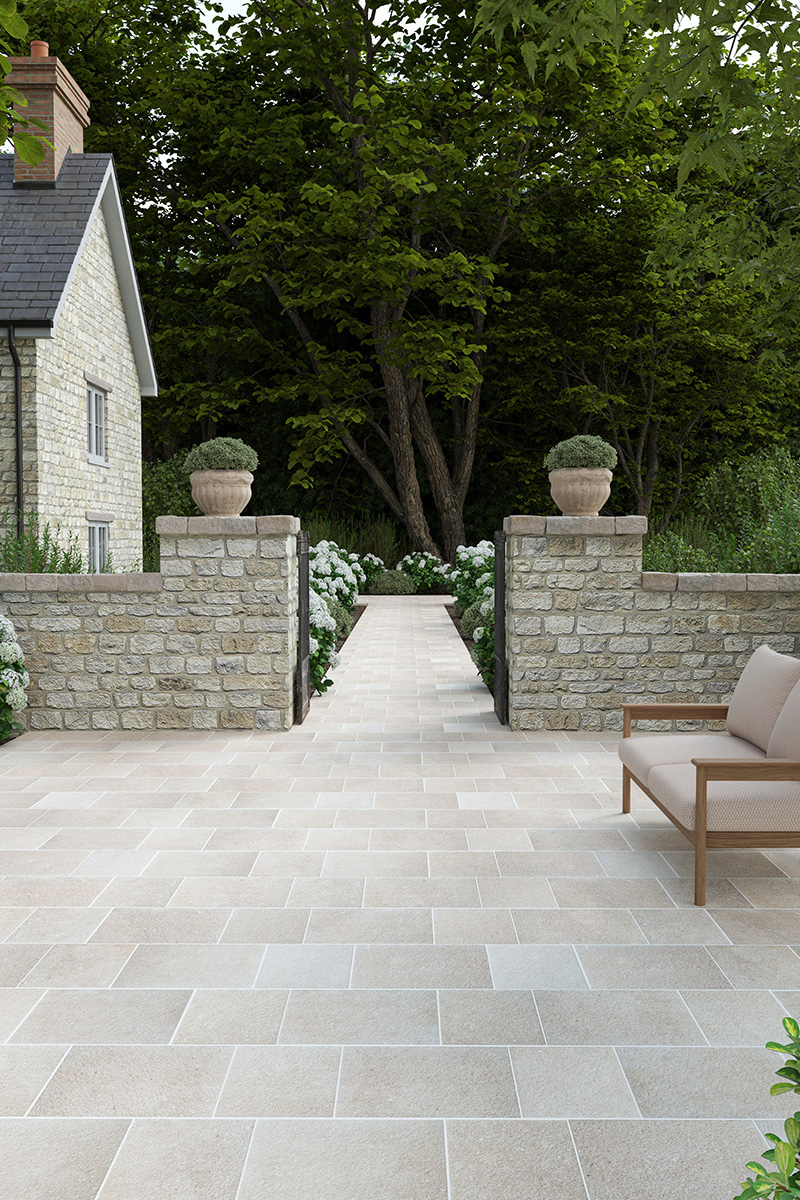 Garden patio pathway with beige porcelain cobbles and brick walls