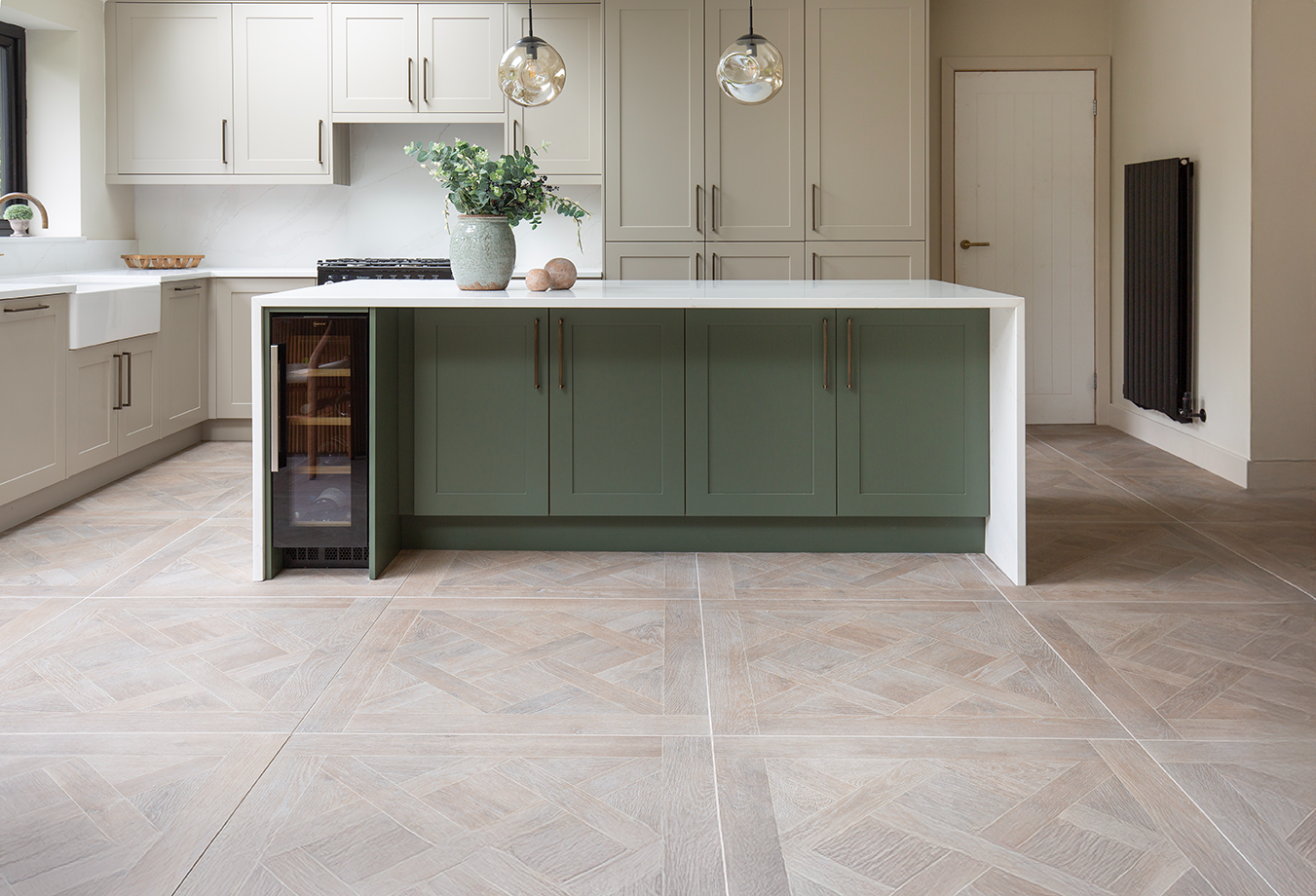 Alderton Oak Parquet on the floor in a kitchen with a green and white island