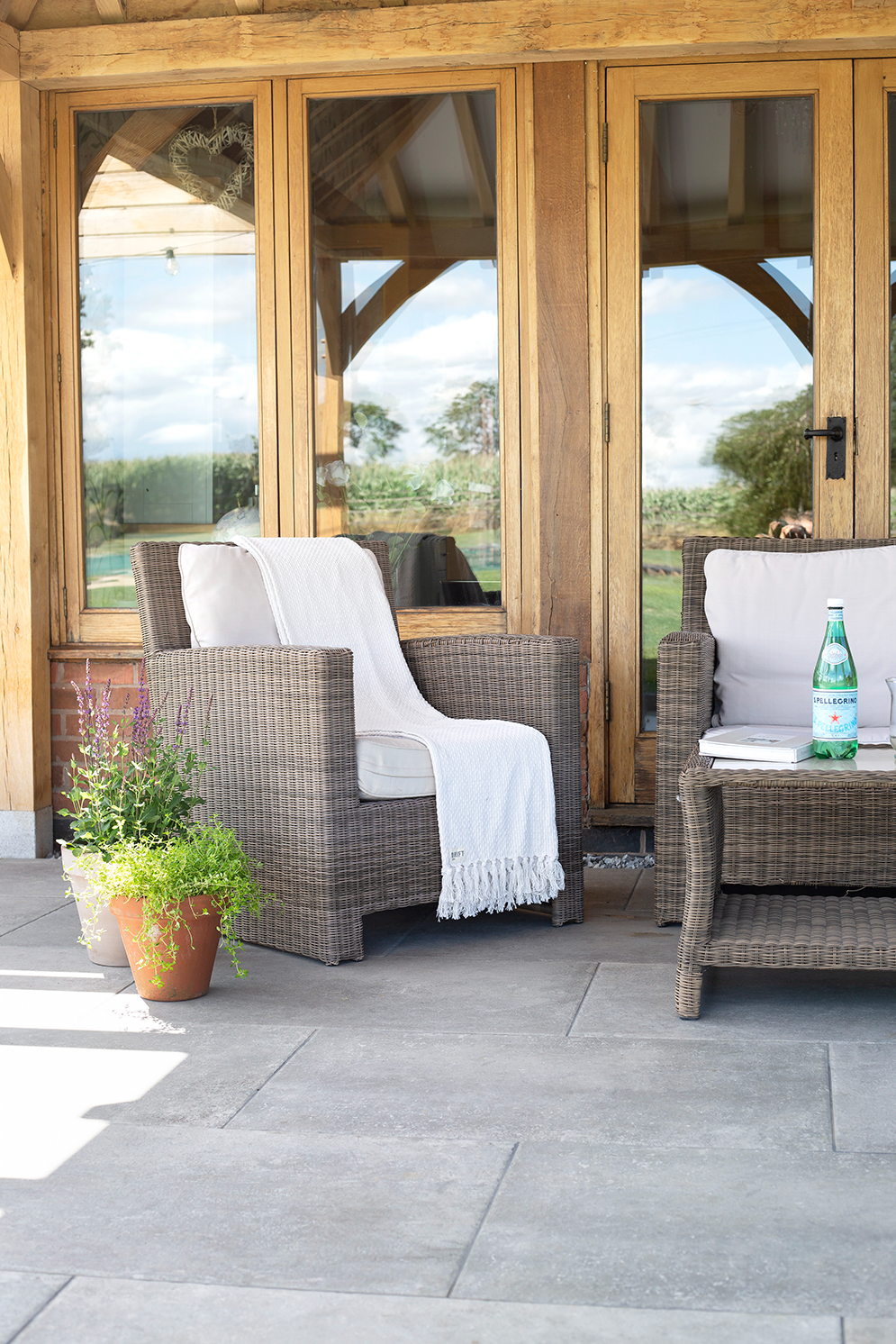 Patio paving with Provence grigio with outdoor seating and wooden building