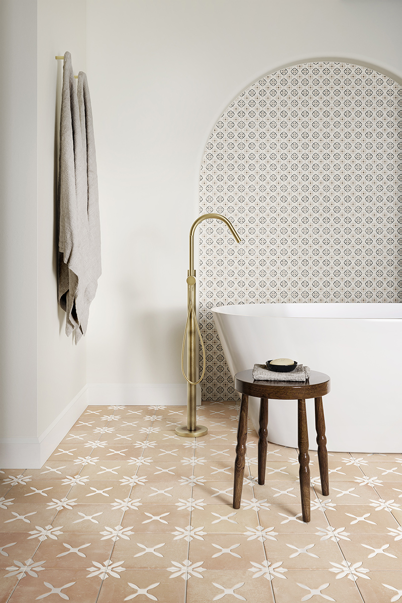 white bathroom with terracotta effect floor tiles and freestanding bath arch