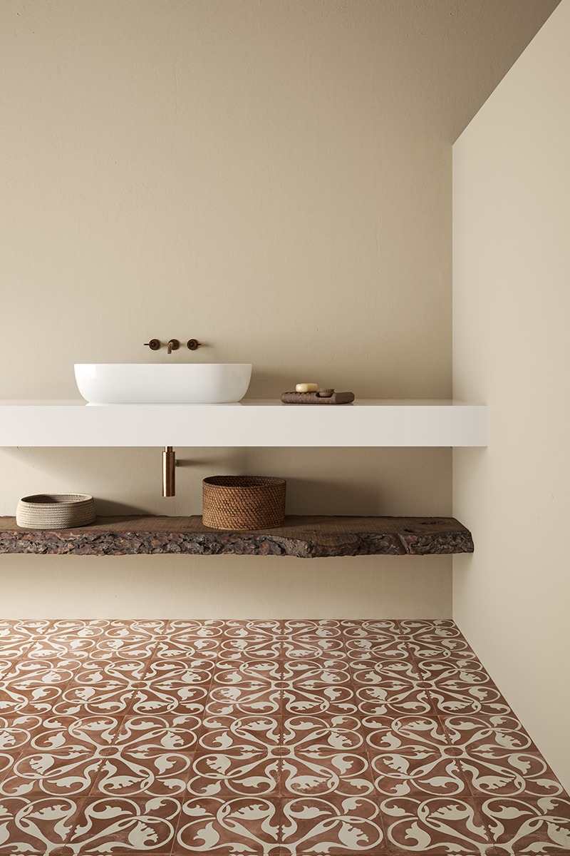 Modern bathroom tile inspiration with patterned floor tiles using Deia Rojo adding colour and character to contemporary bathroom floors.