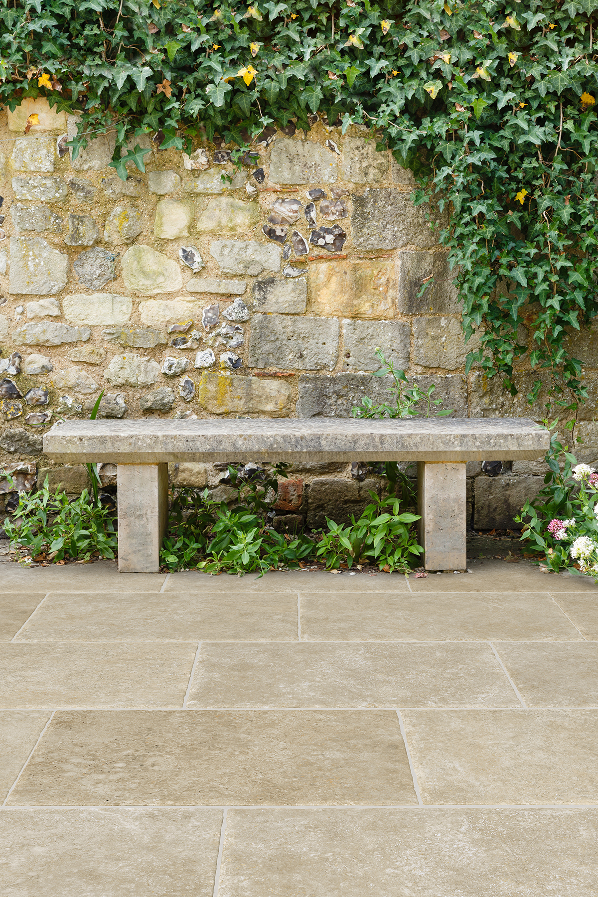 Pavers in rustic garden with Alnwick Beige pavers and bench