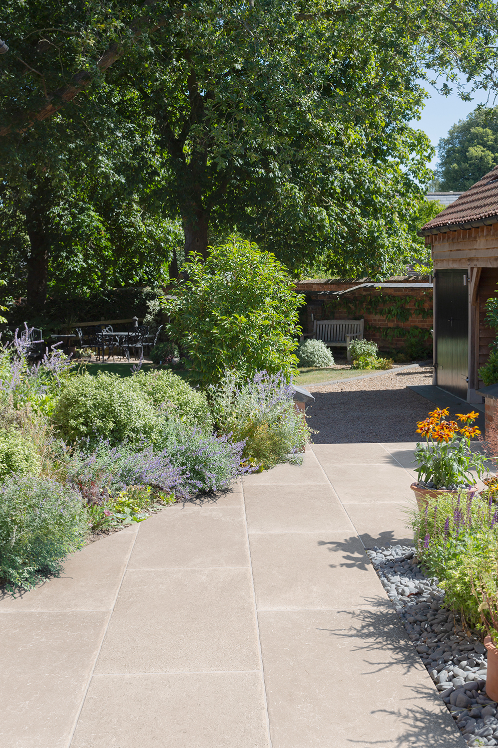 Garden pathway with Hambleton Ivory with a flower border
