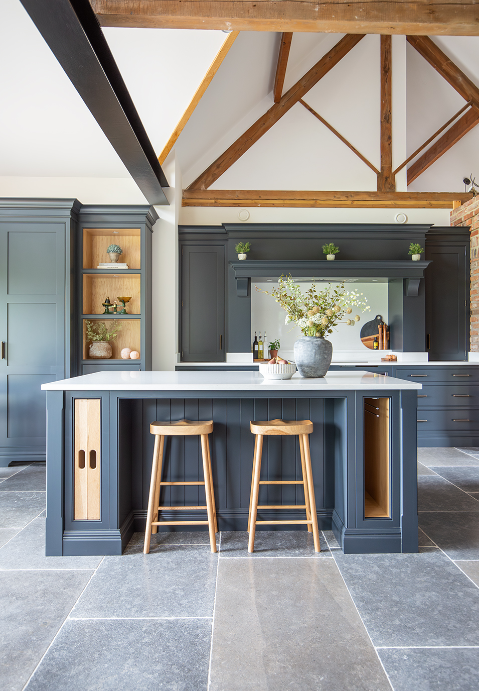 Farrow Grey kitchen floor tiles with a dark blue kitchen and wooden beams