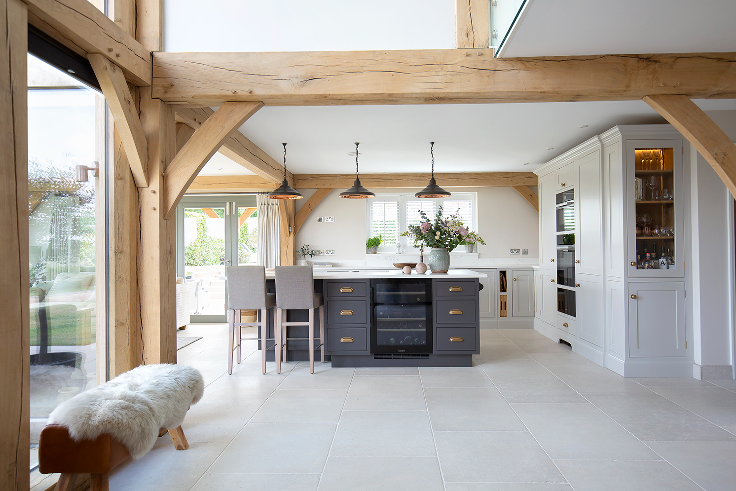 barn conversion kitchen with natural stone flooring and navy blue island