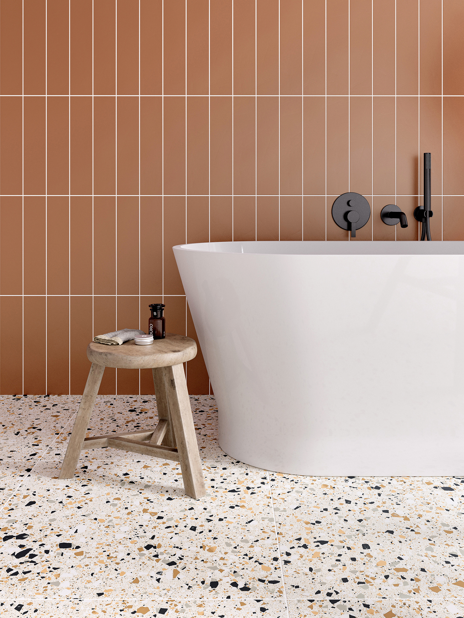 Terazzo Ivory Porcelain tiles with a white bath and terracotta metro tiles on the wall