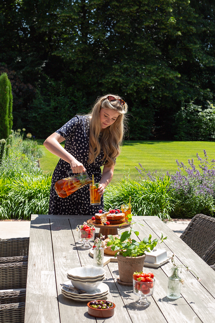 outdoor summer garden table styling with pimms and strawberries