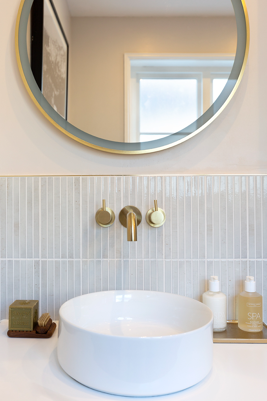 modern white bathroom sink and mirror with kit kat tiles