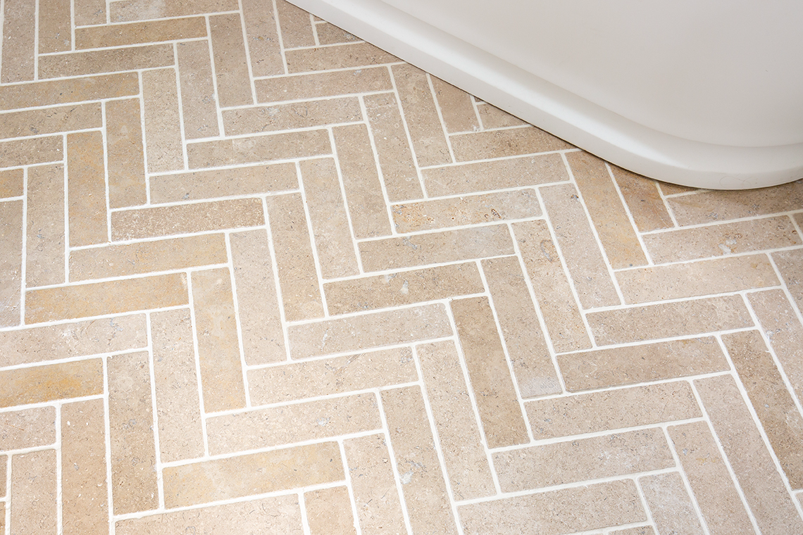 Dijon Tumbled Herringbone Bathroom Tile Closeup