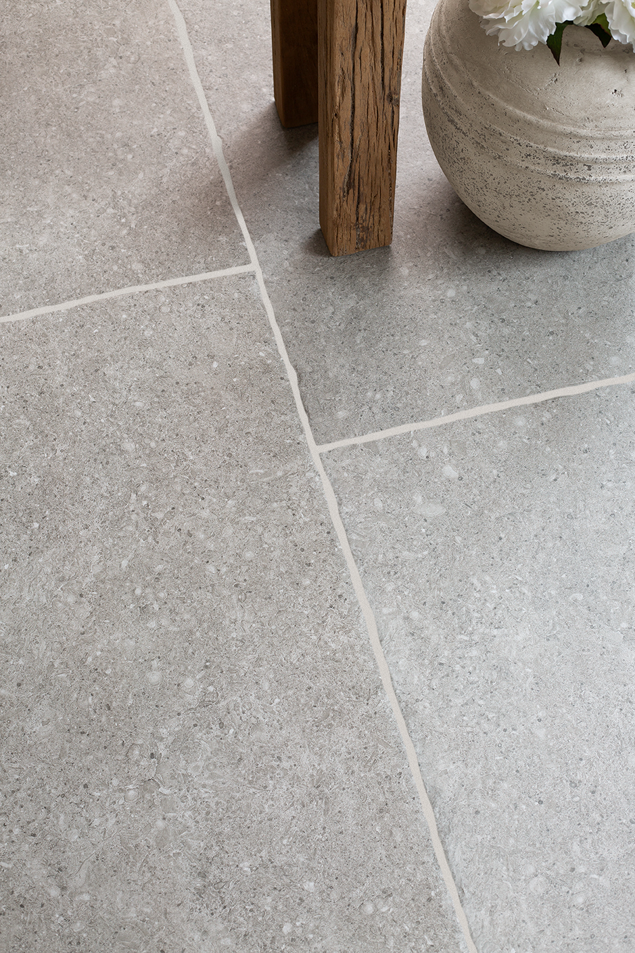 Flat lay with Ancroft Grey pavers with wood and pot