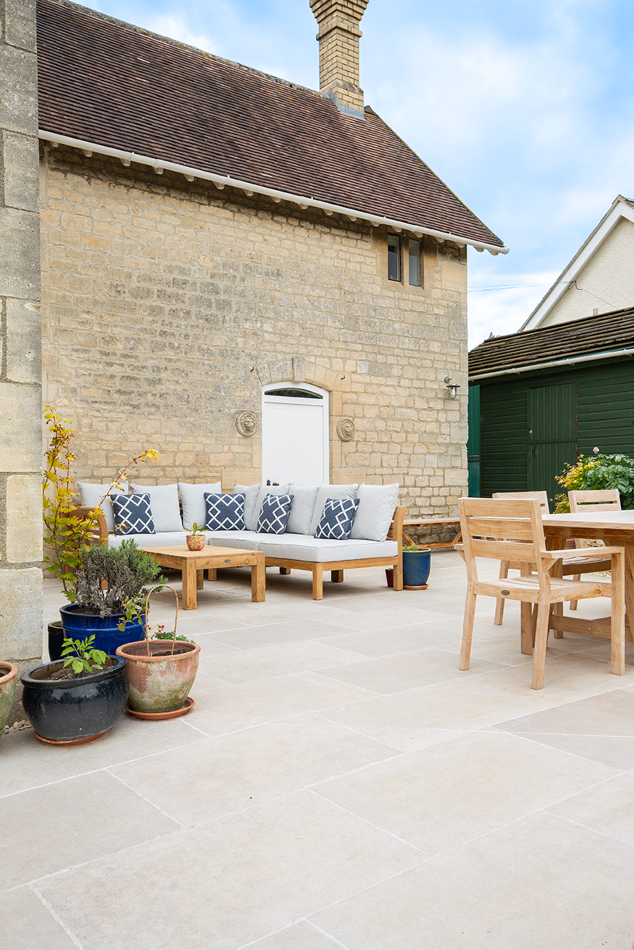 A Chastleton Ivory patio with a table and chairs