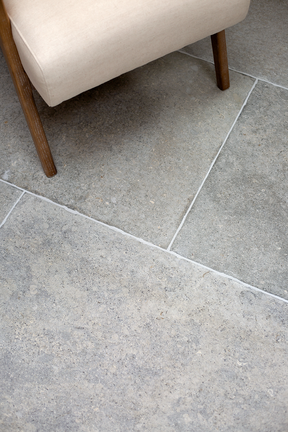 Montpellier Gris close up tiles with cream chair