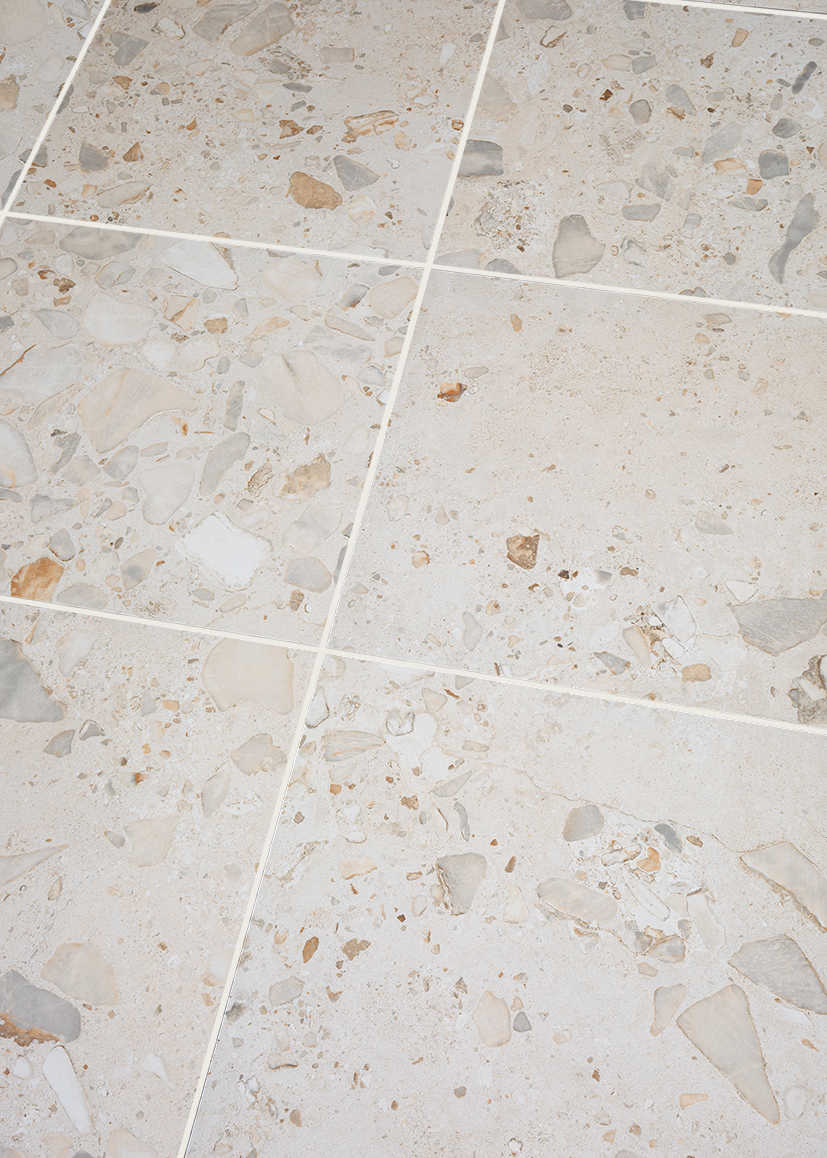 close up of stone effect porcelain with shell and pebble details