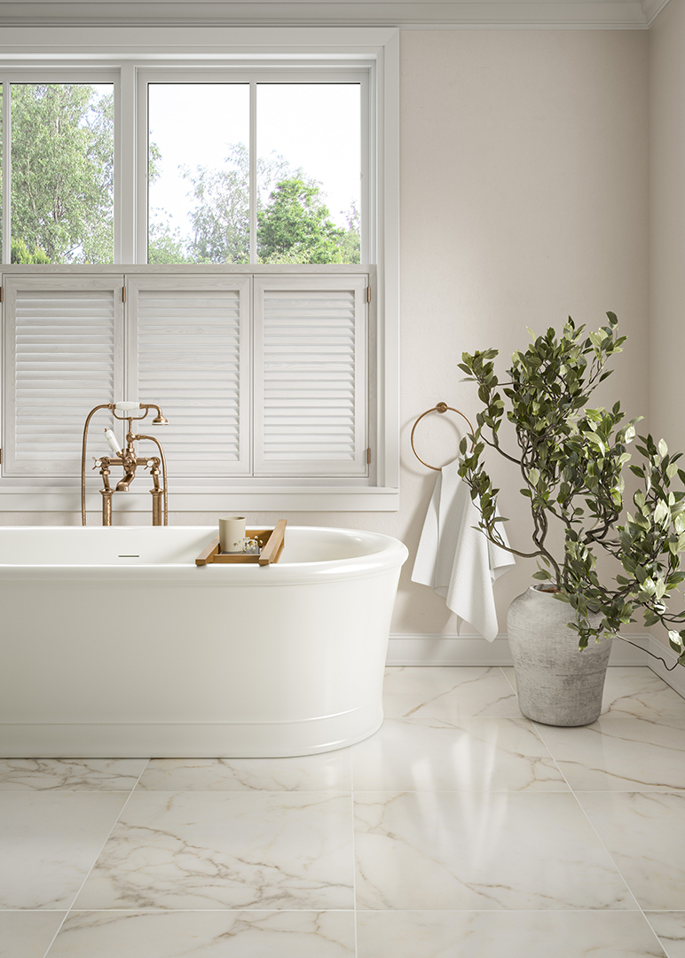 Ravello Borghini marble effect floor tiles with a white bath and window looking out to a garden