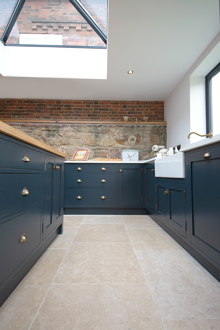 Dijon tumbled limestone floor with blue cabinets