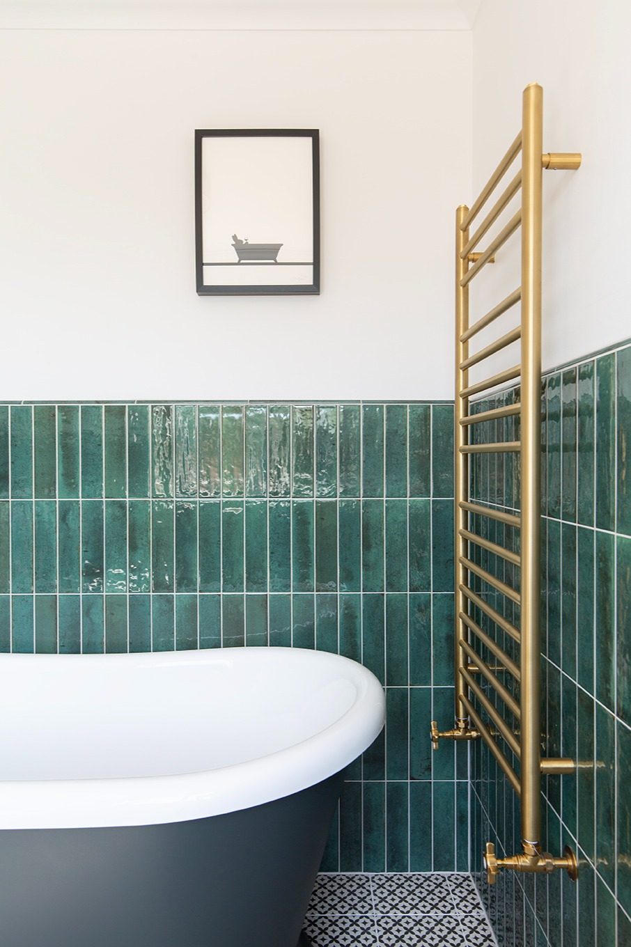 Modern bathroom tile inspiration featuring Hockley Antiqued Green metro tiles paired with a gold railing, creating a rich, contemporary wall scheme with depth and luxury.