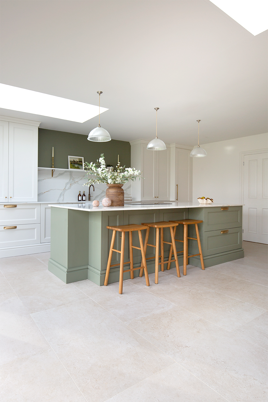Green painted kitchen with stone effect porcelain flooring