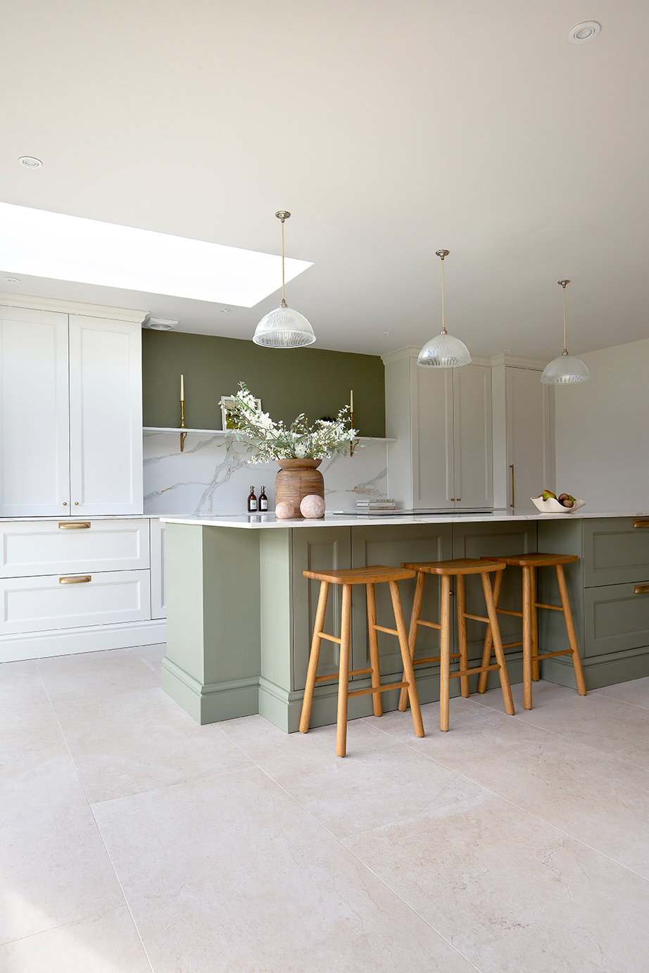 Orwell Natural kitchen floor with a light green island and cream cabinets 