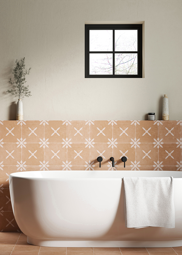 Modern bathroom with a white freestanding bathtub and towel, set against a wall of Salamanca Decor patterned tiles. A black-framed window and minimalist decor add elegance.