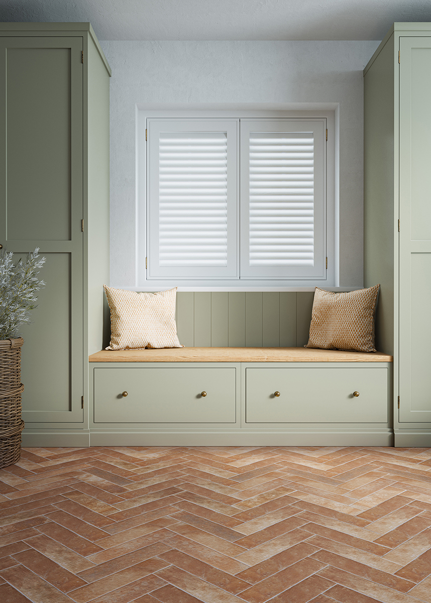 terracotta herringbone floor tiles in boot room with sage green furniture