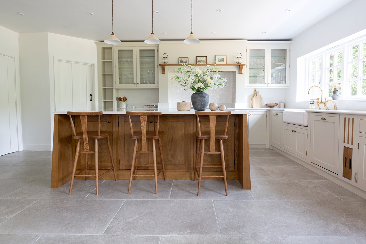 Kitchen with Hambleton Taupe floor tiles with a wood island and stools