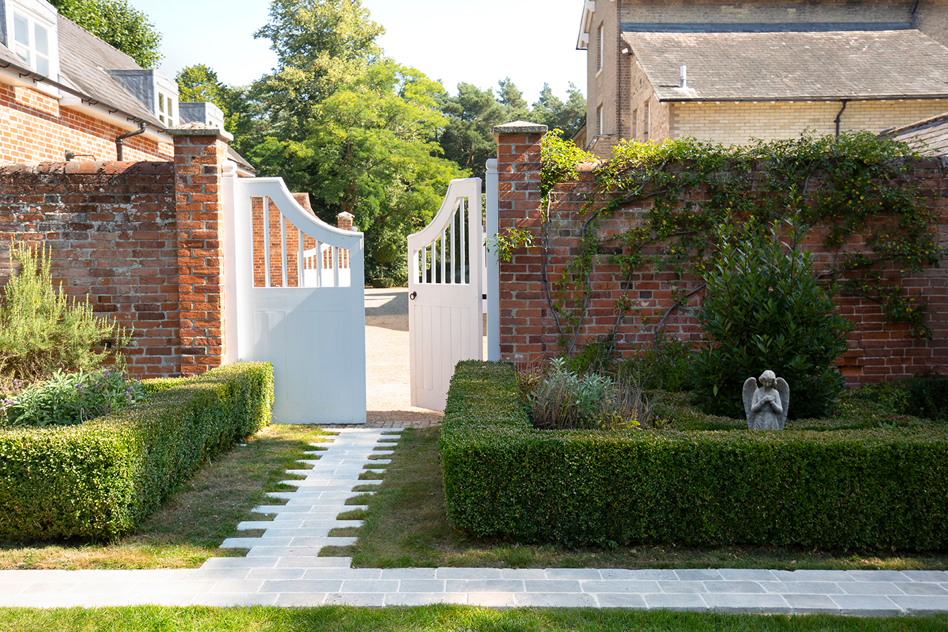 A Clermont Aged tumbled cobbles leading towards a gate into a courtyard