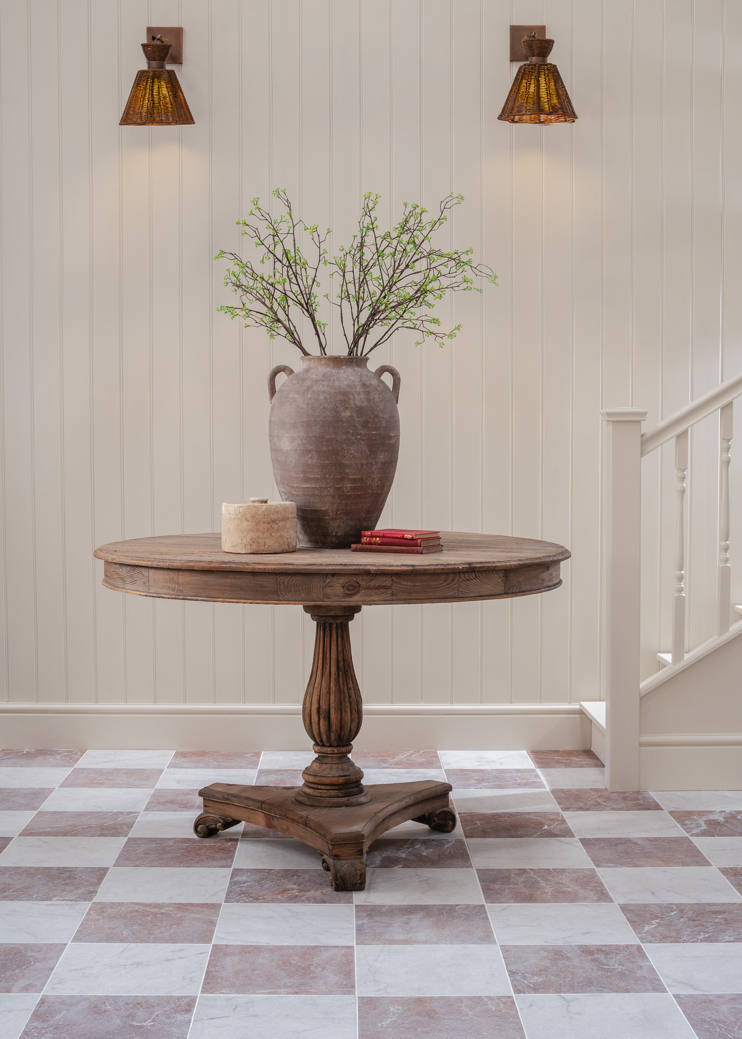 Chalfont Red and White chequered tiles with a wooden round table with terracotta vase on top 