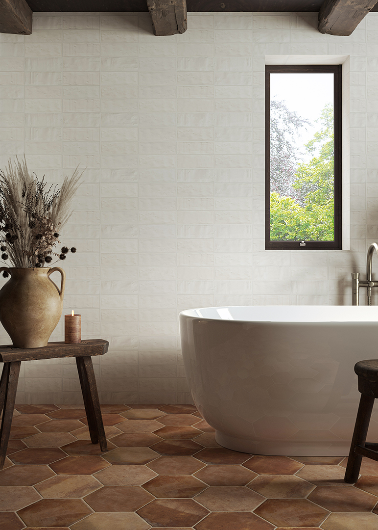 hexagon terracotta floor tiles with free standing bath and wooden stool