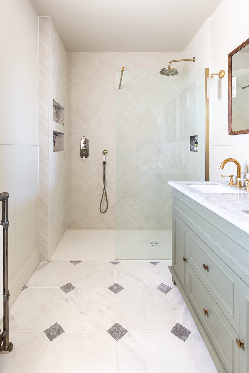 Parisian manoir cabochon floor tiles in a bathroom with a blie vanity