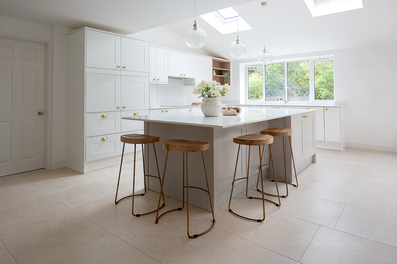 Ivory porcelain stone effect tiles in a neutral kitchen with an island