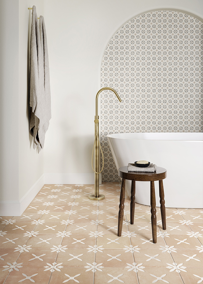 a bathroom with a bathtub and stool with Salamanca Sand Terracotta effect decor on the floor