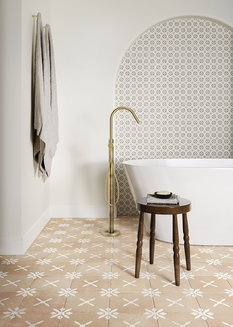 terracotta floor tiles in bathroom with freestanding bath and archway