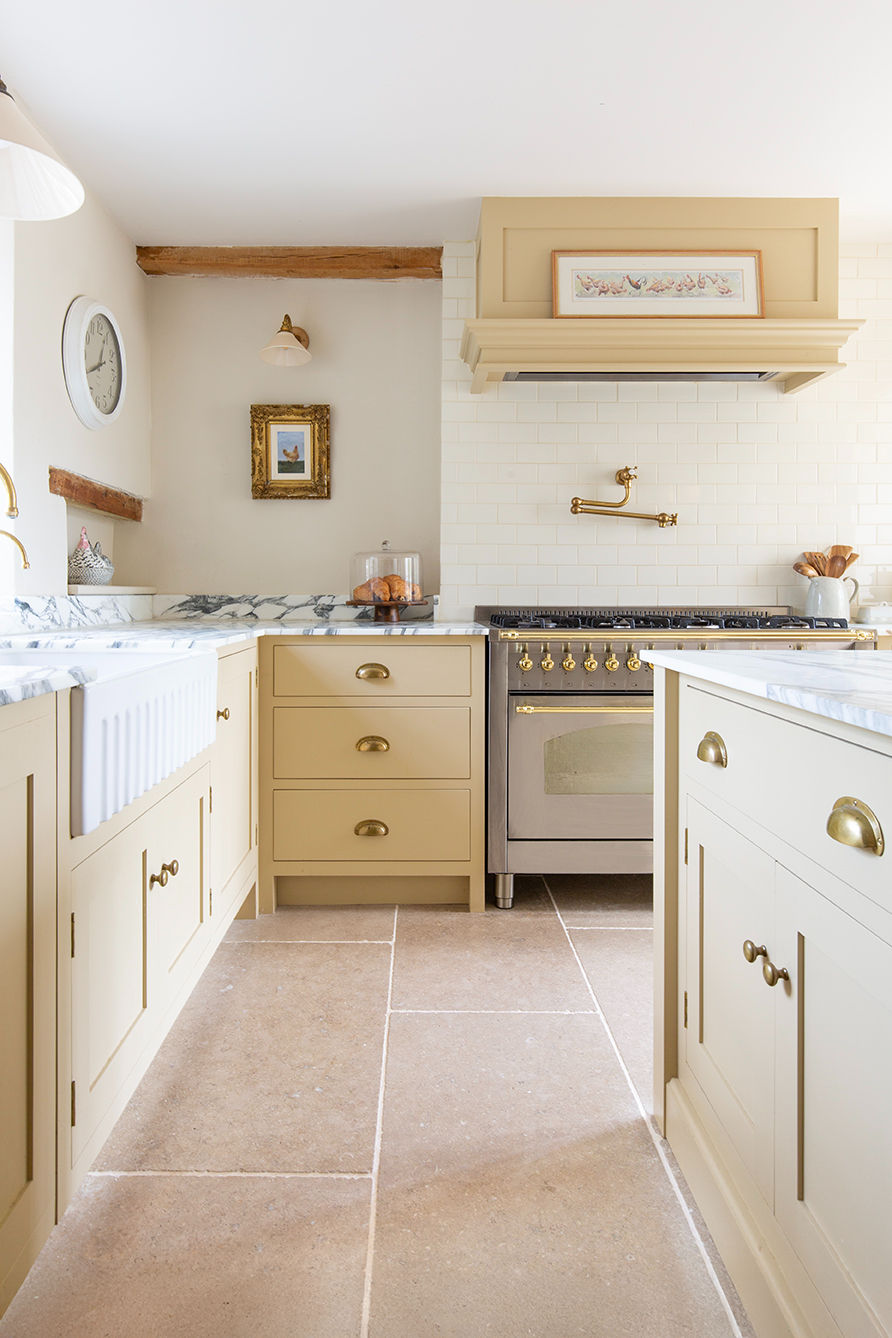 Dijon tumbled limestone flooring in butter yellow kitchen 
