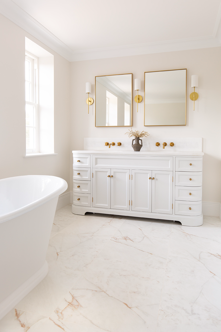 Carrara Rosa Pink marble effect tiles with a bath and ivory vanity 