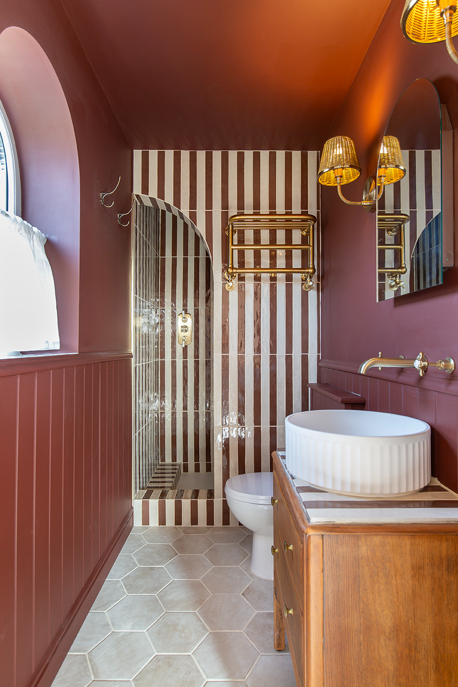 Luella Claret Red striped tile in a moody red bathroom