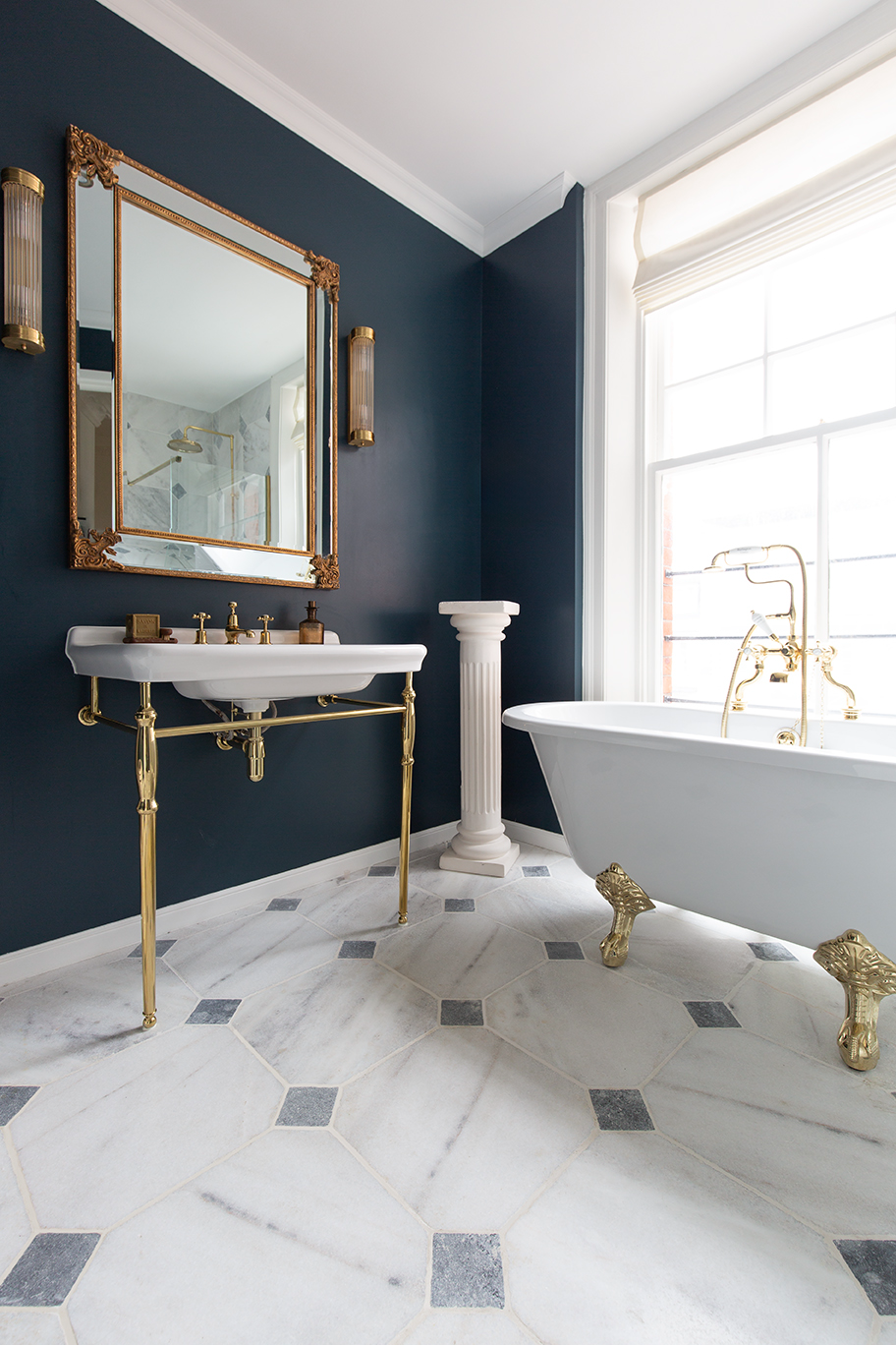 A bathroom with a sink and mirror Parisian Manoir 