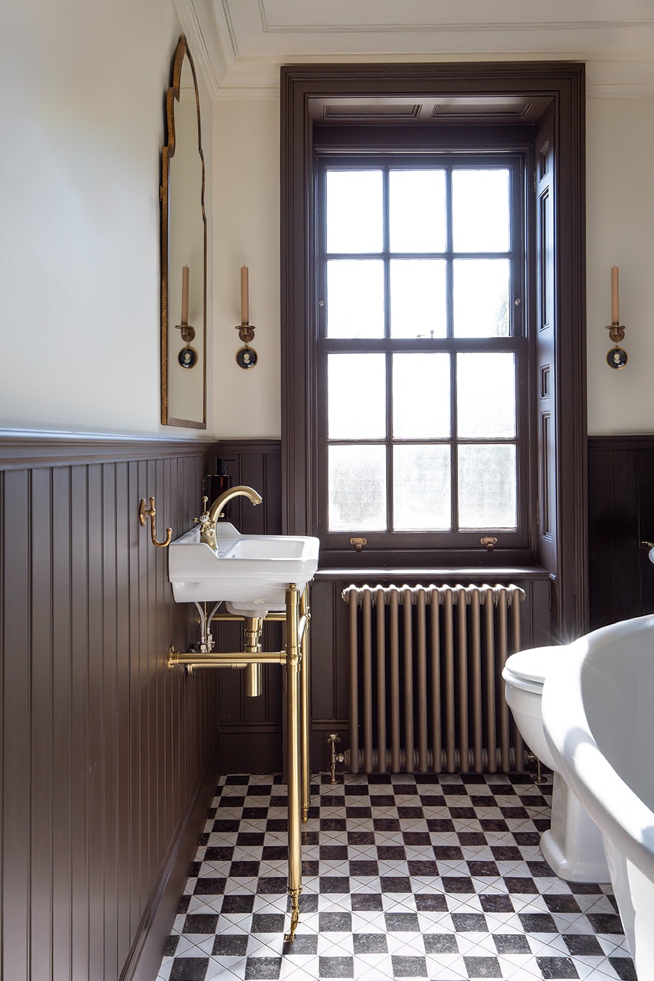 Modern bathroom tile inspiration showing chequerboard floor tiles with Julieta black and white tiles, creating a striking graphic design.