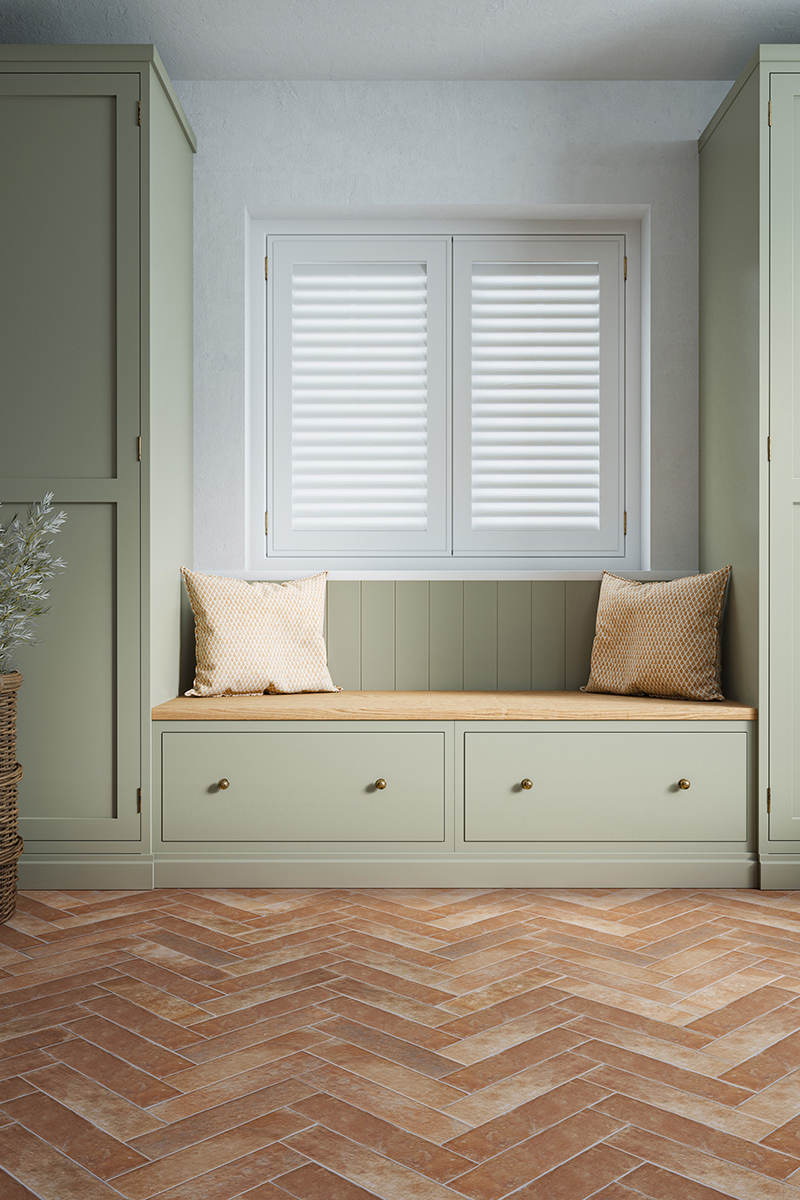 terracotta herringbone floor tiles with green boot room